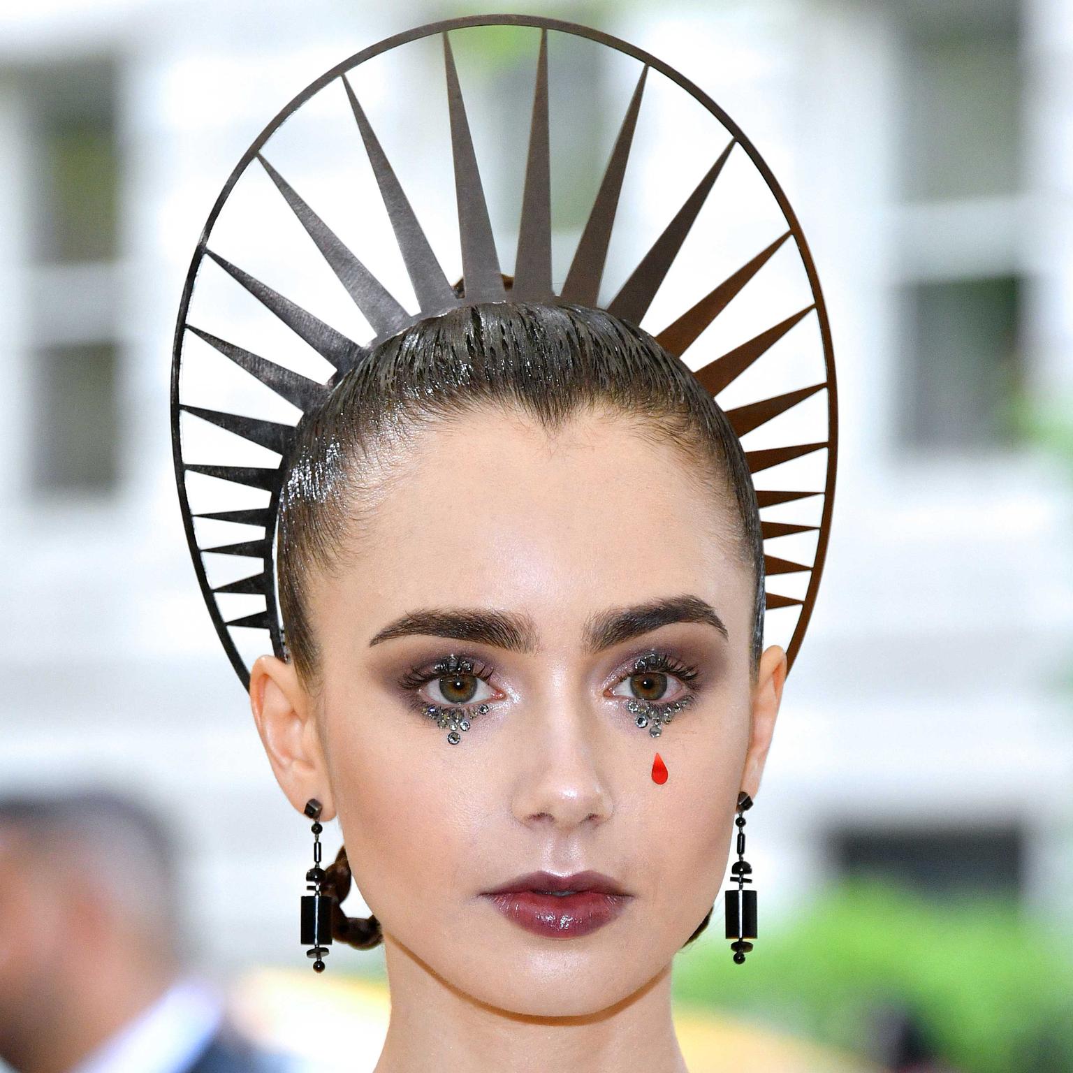 Lily Collins wears 1929 Cartier onyx earrings at the Met Gala 2018 in New York. 