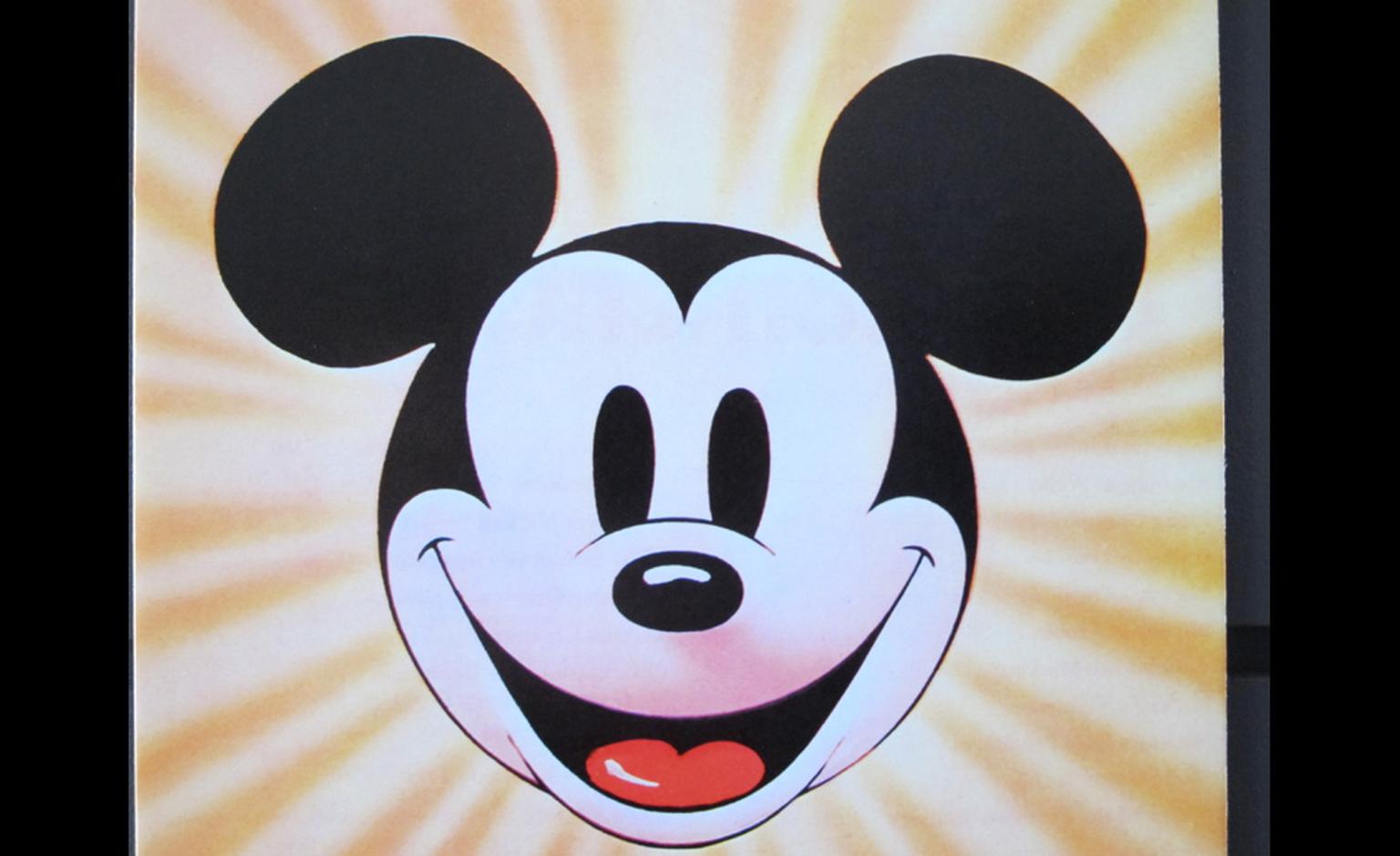 Beaming out, Mickey Mouse in his youth.