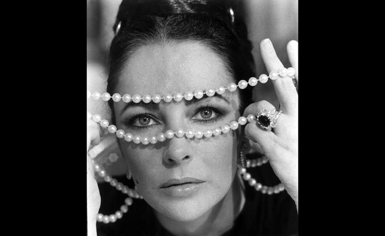 A gift from Richard Burton in 1968, Liz wears the ruby ring in this iconic shot.