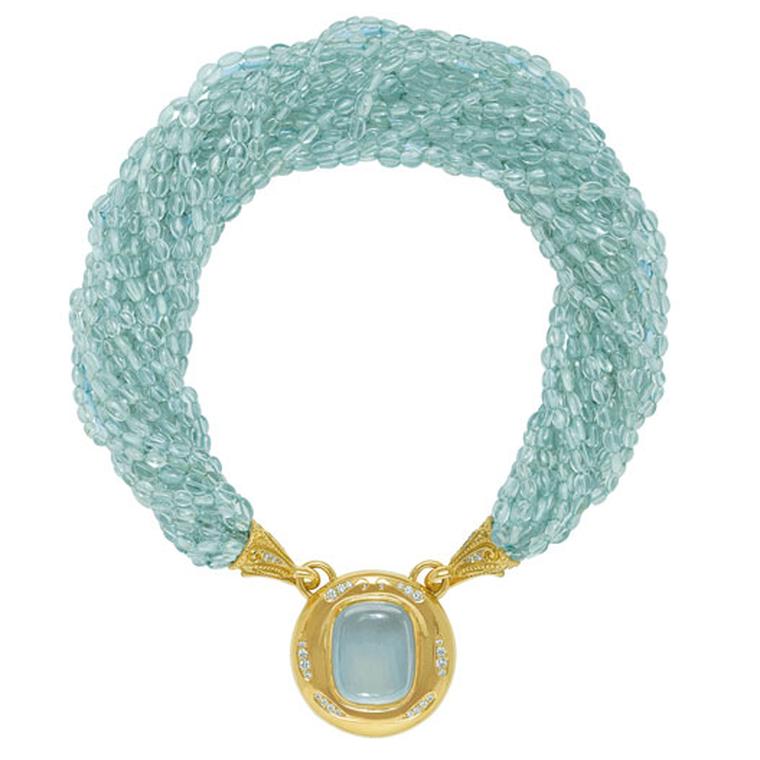 ELIZABETH GAGE, Aquamarine Neckalce Detachable pendant featuring a fabulous cushion-shaped cabochon aquamarine set in a gold and diamond surround, hanging from a multi-strand aquamarine bead necklace. The gold funnels are decorated with diamonds.POA