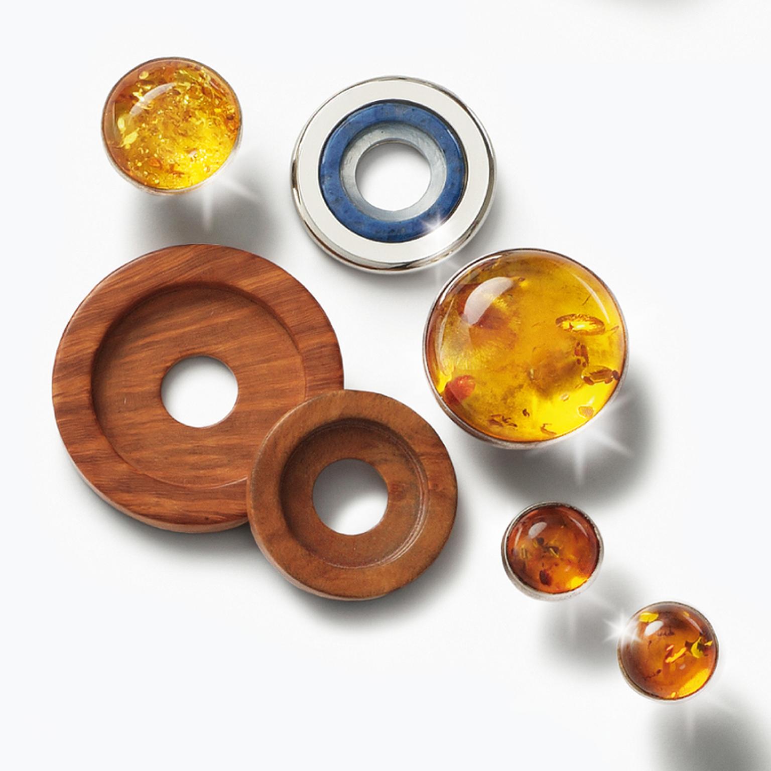 Charlotte Ehinger-Schwarz 1876. Baltic Colours. Earrings, pendants and rings with blue sapphires, fire enamel, stainless steel disc, faceted rock crystal over mother of pearl,  aquamarine, amber, bruyere wood.  All pieces sold separatley. Prices...