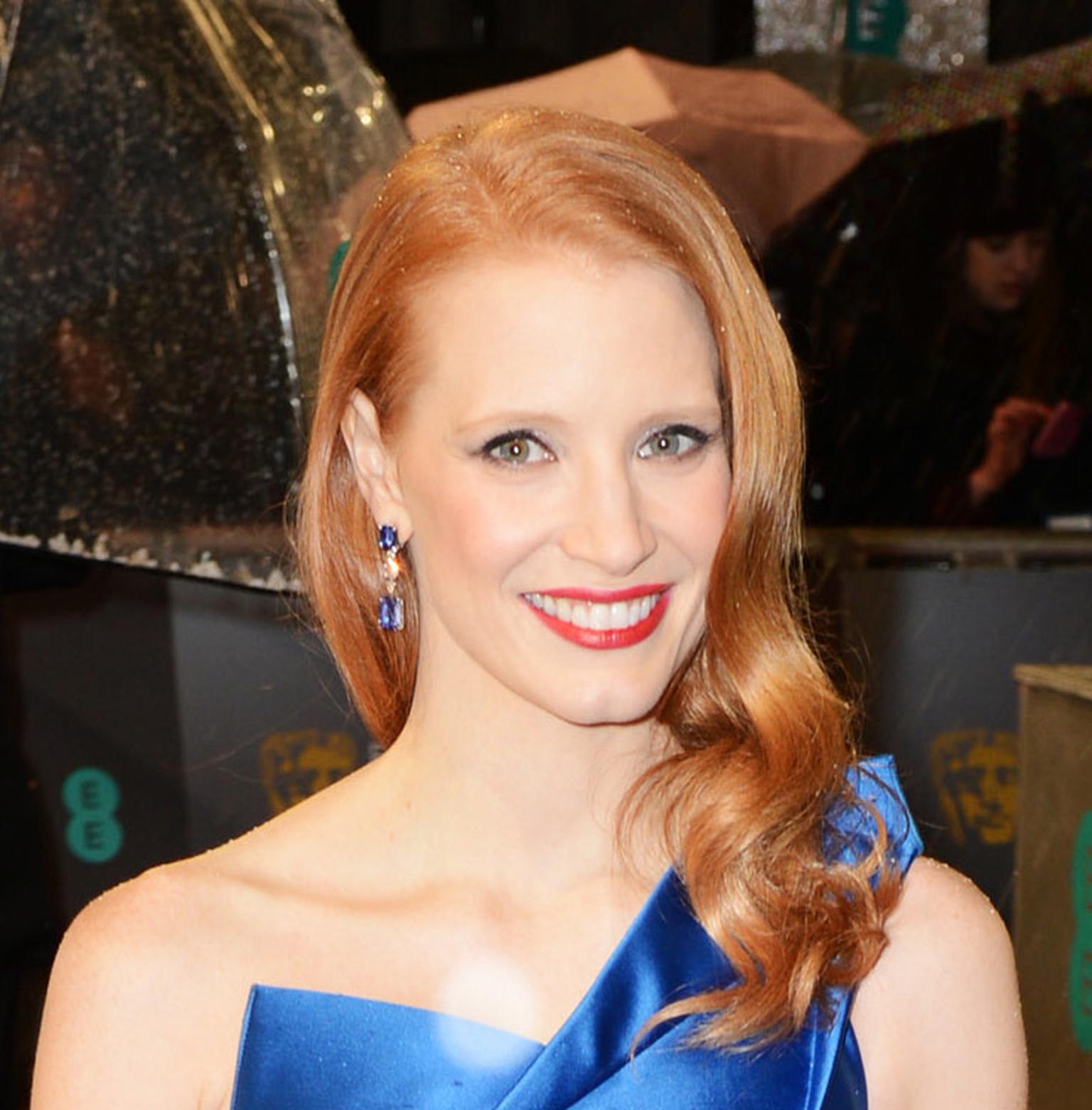 Jessica Chastain arriving at the 2013 BAFTAs in Harry Winston sapphire and diamond earrings, set in platinum