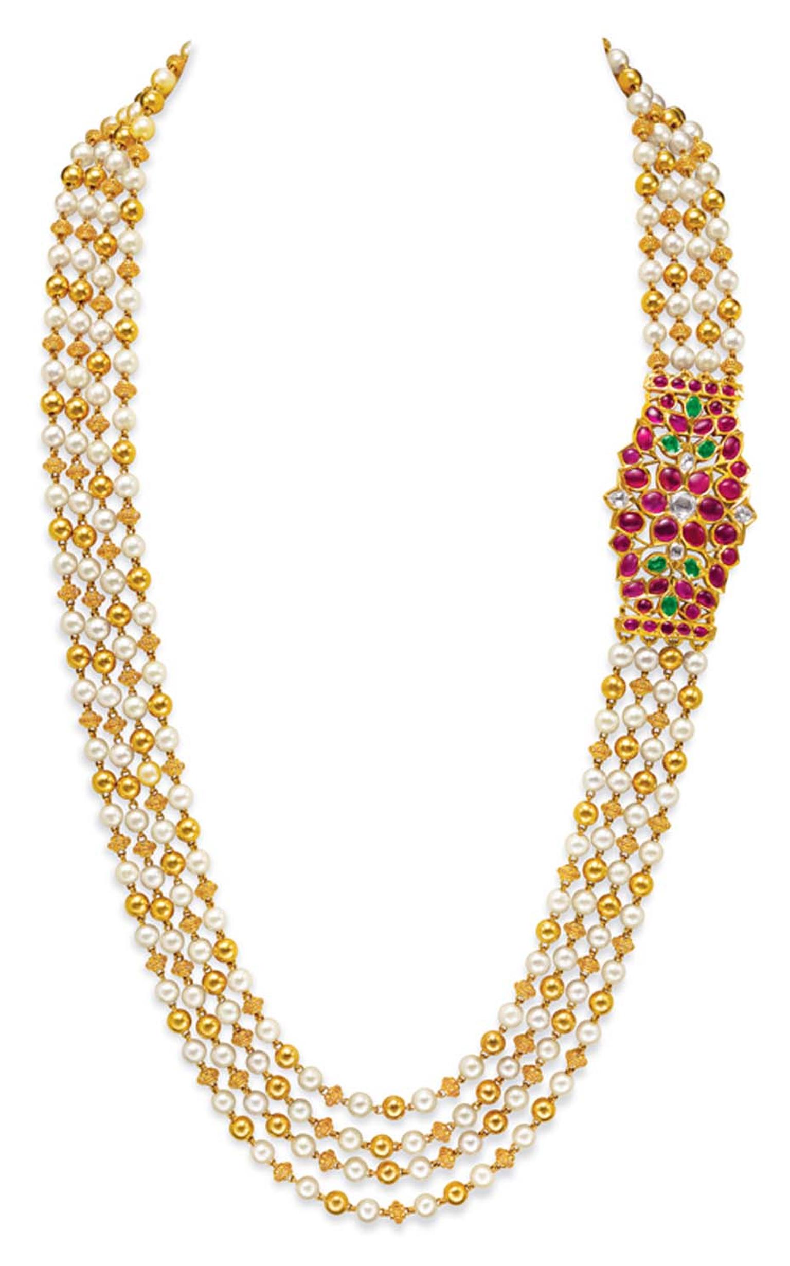 Ganjam's pearl and gold beaded multi-string necklace with a ruby-set side brooch.