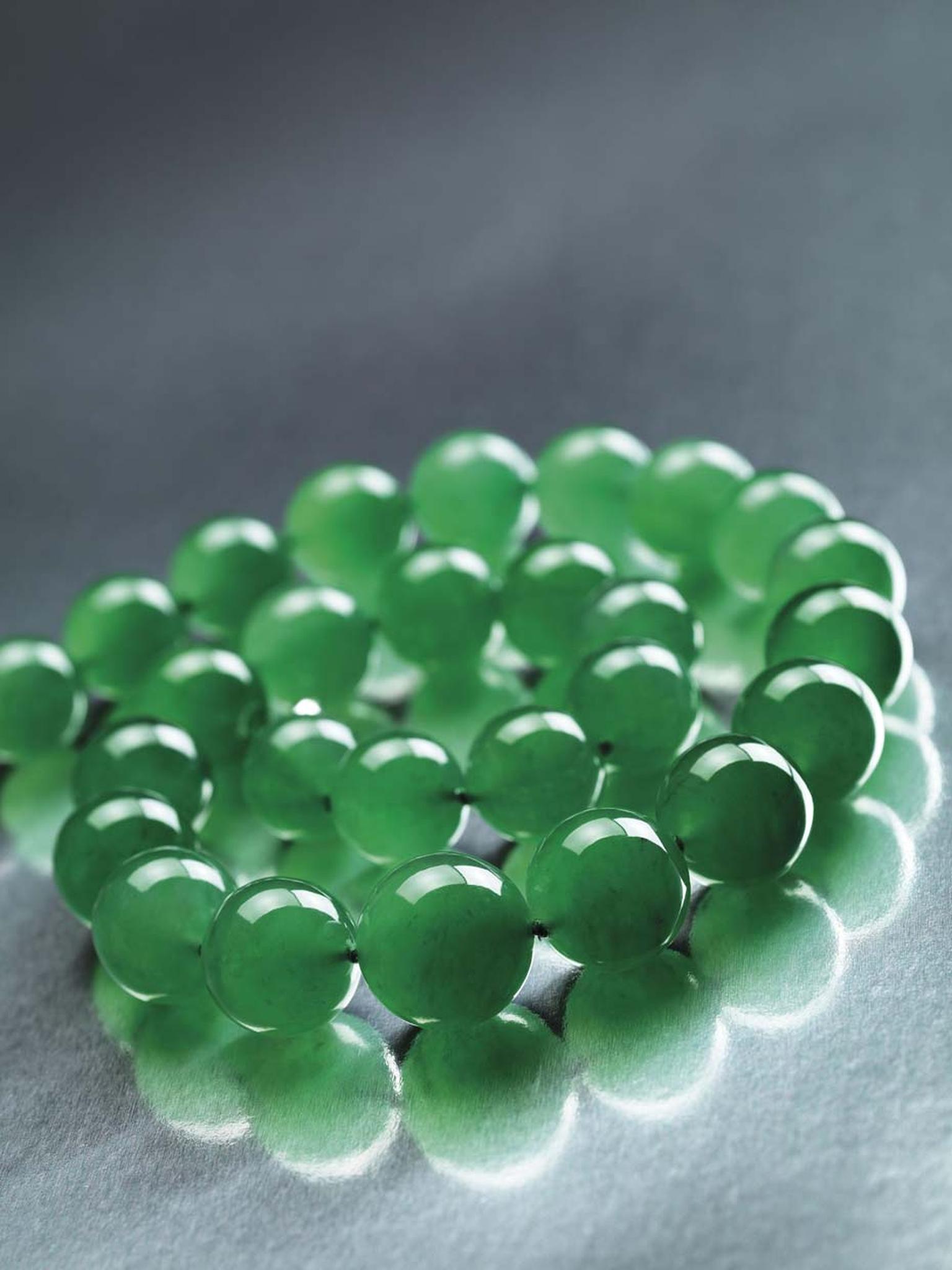 The 27 gigantic, vivid green jadeite beads in the Hutton-Mdivani jade necklace are all of excellent translucency and an extremely fine texture, with diameters ranging from 19.2mm to 15.4mm