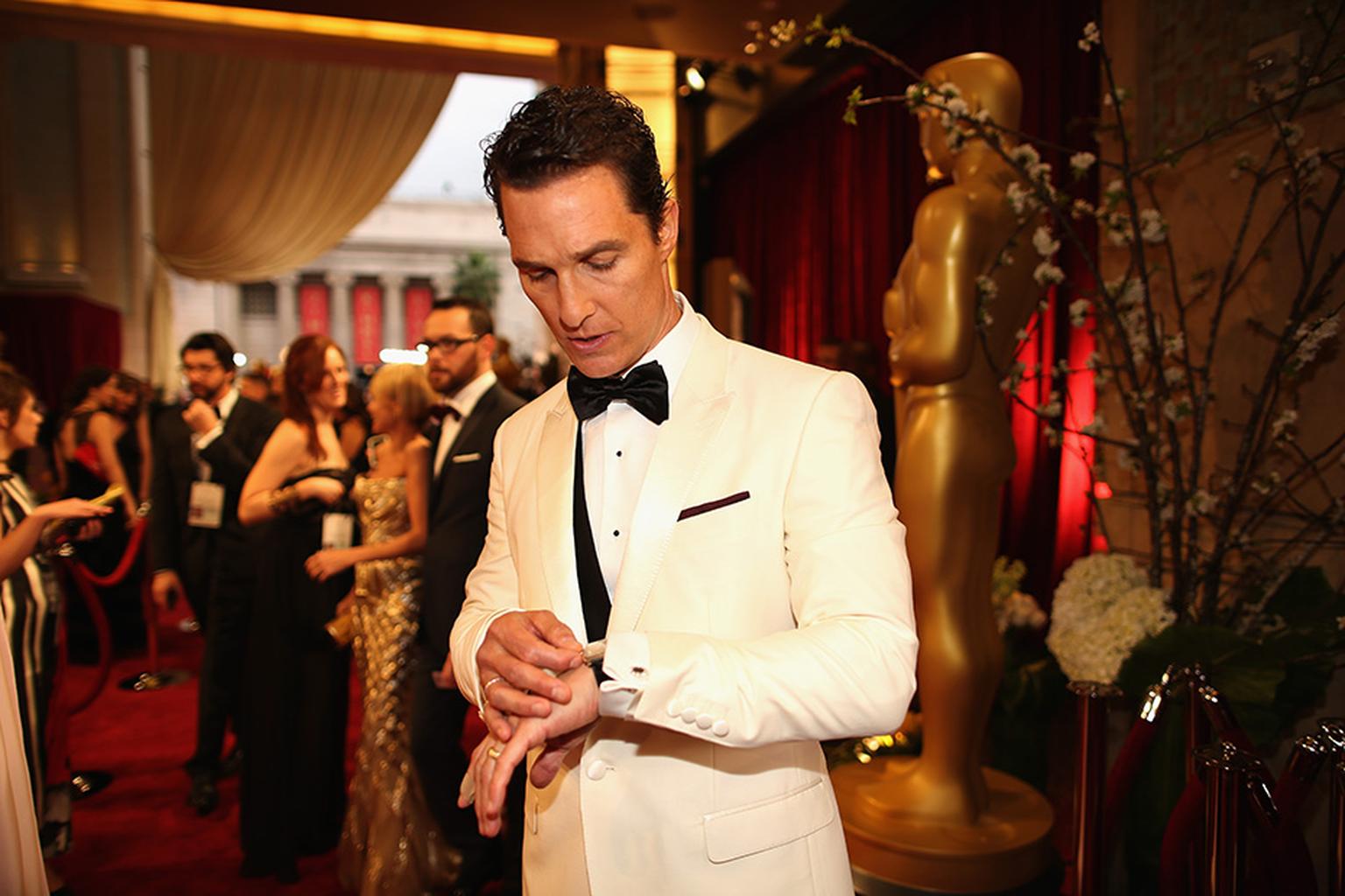 Matthew McConaughey checks the time on his white gold Chopard L.U.C XP Tonneau watch