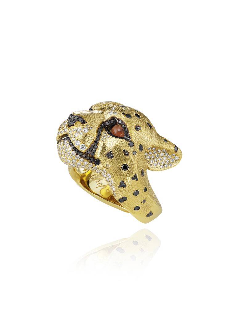 Harumi for Chopard leopard ring featuring tiny black and white diamonds set into yellow gold and eyes accentuated with black diamonds and orange garnets