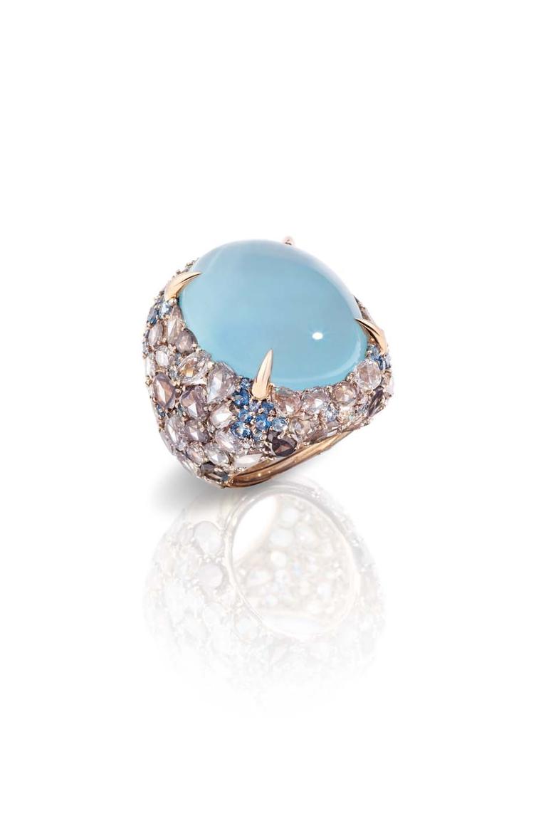 Pomellato Pom Pom collection ring featuring a light-blue cabochon surrounded by aquamarines and a pavé of brown diamonds.