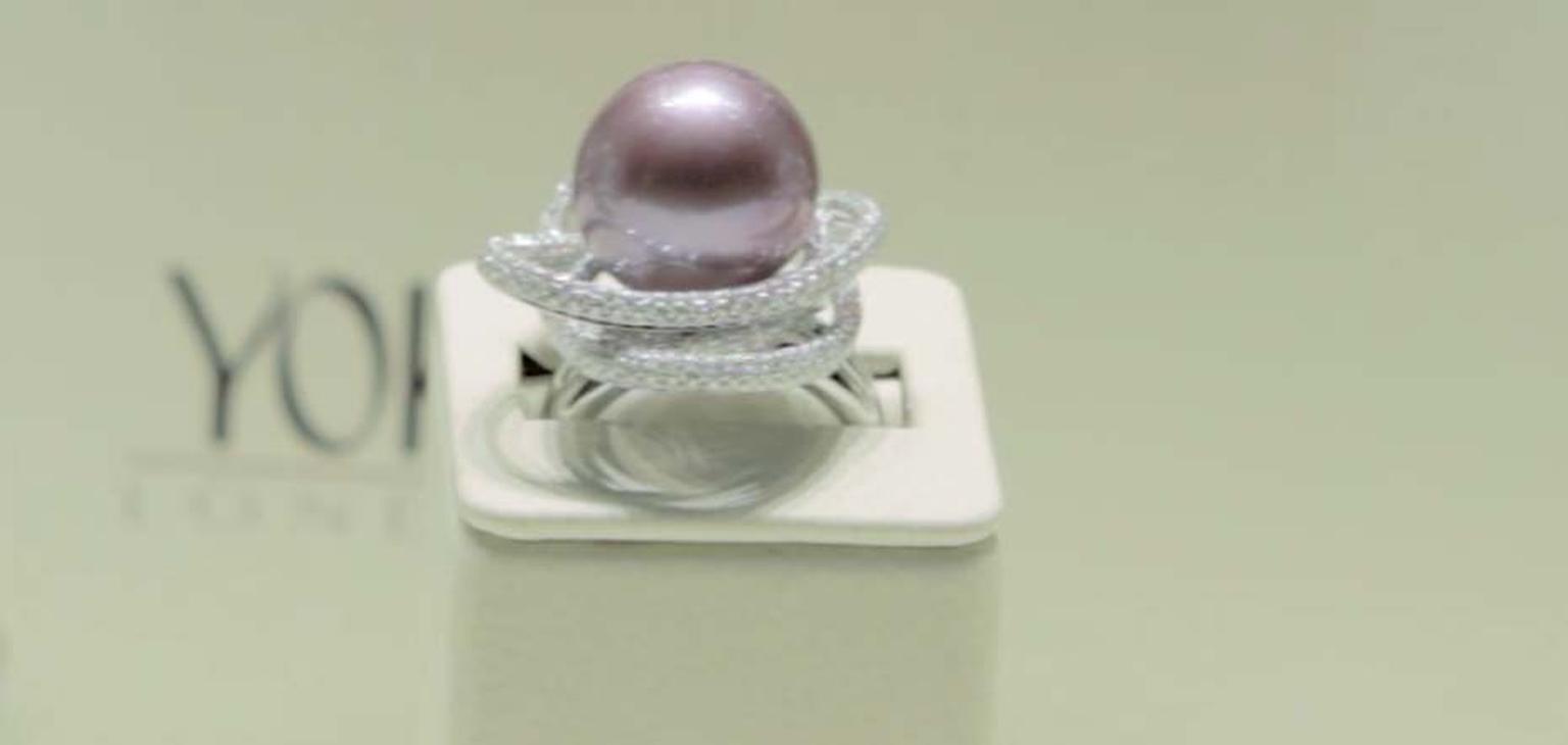 Yoko London purple pearl ring floats in orbit amongst diamonds.