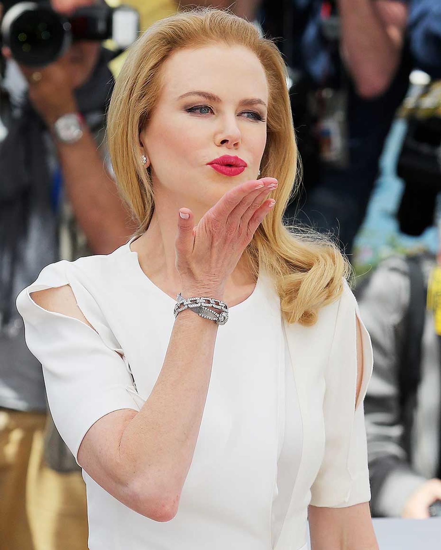 Earlier in the day, at the 'Grace of Monaco' photo call, Nicole Kidman paired her demure white dress with a Harry Winston Diamond Links bracelet and diamond earrings and a vintage diamond-pavéd Omega "secret watch" dating from 1955