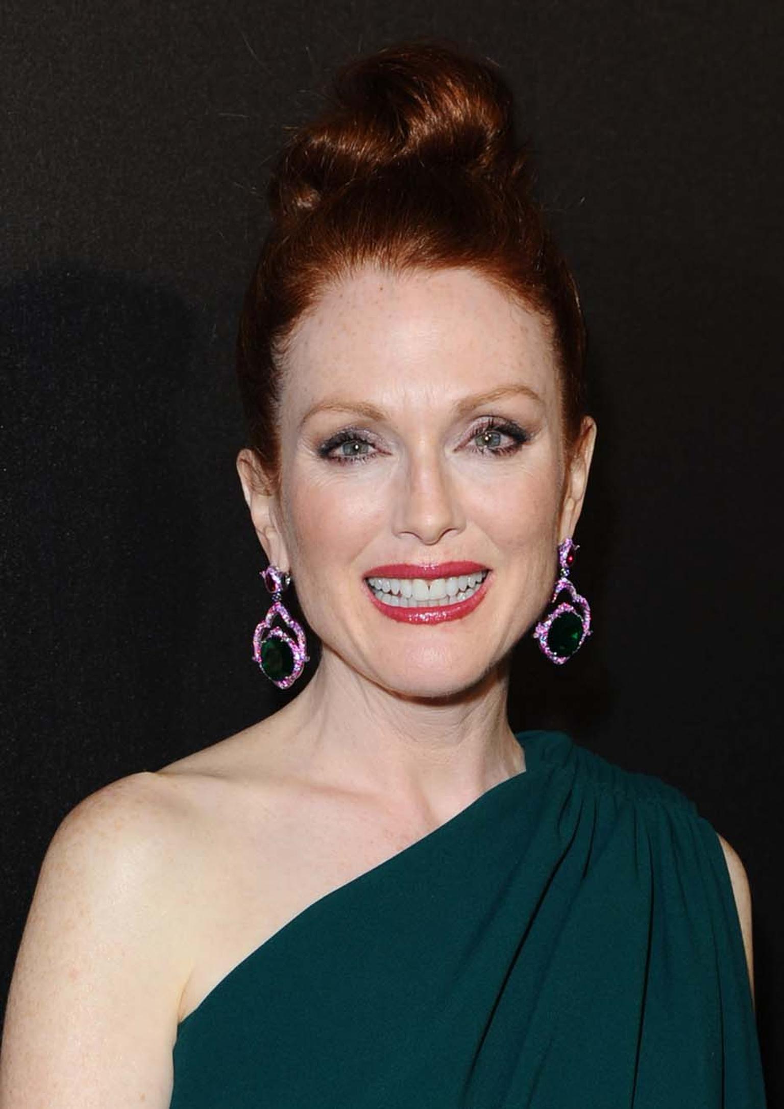 Julianne Moore attended the Hunger Games party wearing a pair of earrings from Chopard's 2014 Red Carpet collection - the first time these colourful jewels, set with 44ct emeralds surrounded by pink sapphires and rubies, made a red carpet appearance.