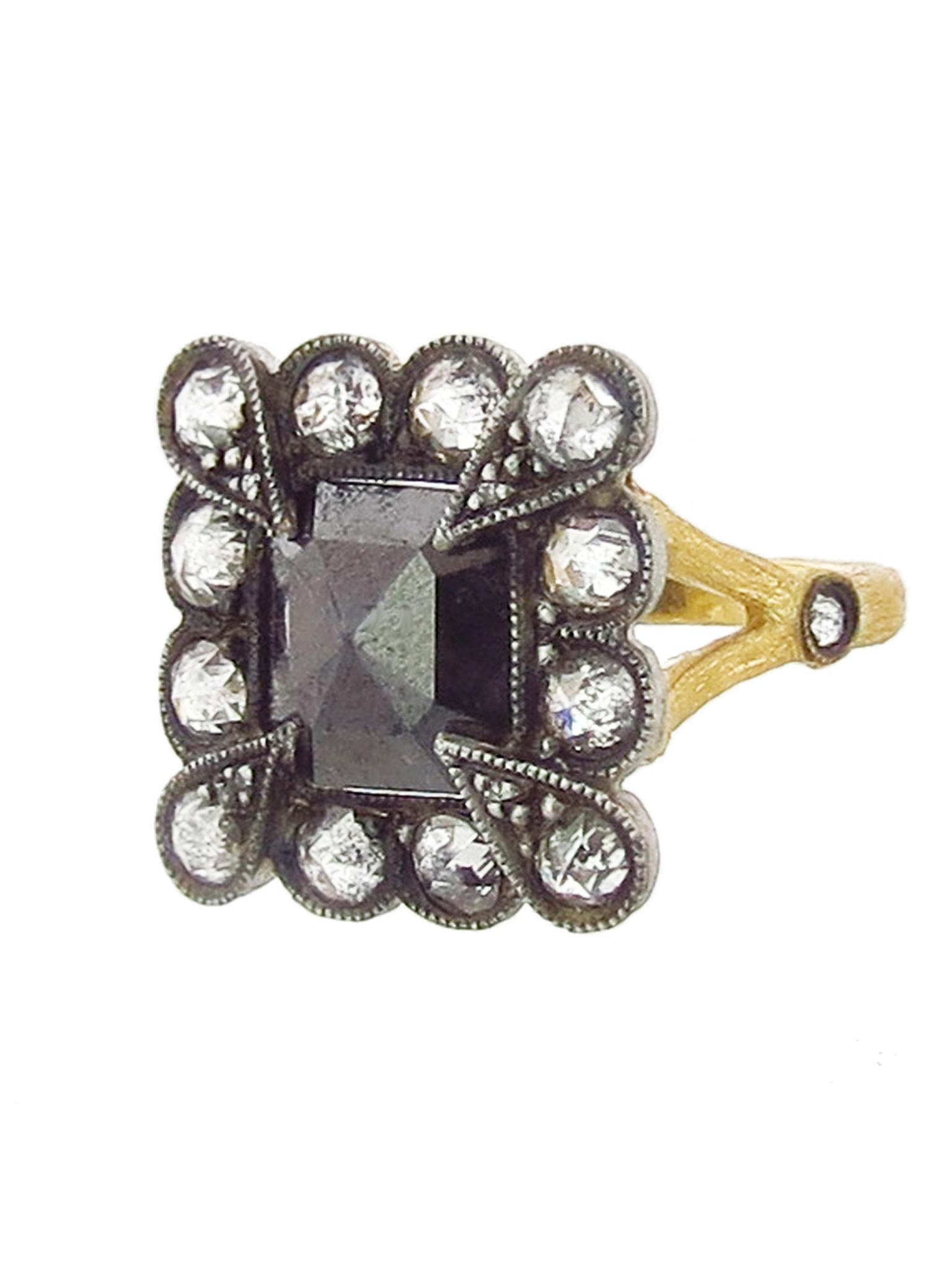 A one-of-a-kind Cathy Waterman black diamond Lace Edge ring featuring a 2.65ct diamond in a scalloped frame of white diamonds on her signature branch band in 22ct gold. Available at Ylang 23 (£5,355.18).
