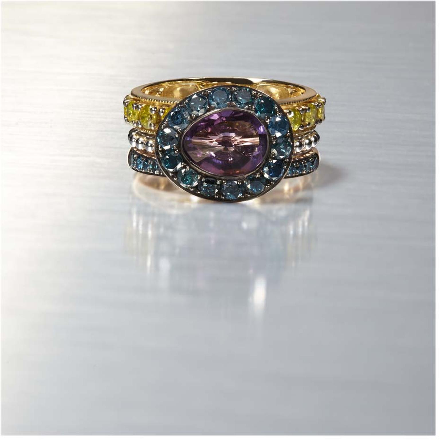 Annoushka Dusty diamond rings featuring a centre amethyst ring outlined in blue diamonds and stacked with a yellow diamond ring on top and a green diamond ring below.