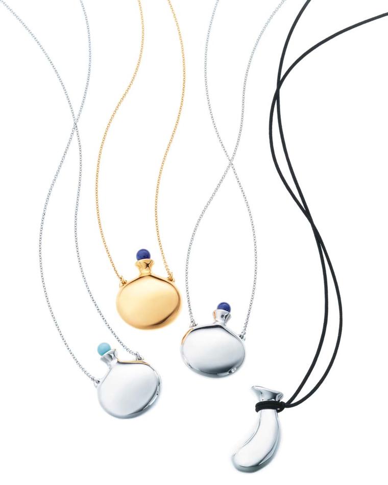 Elsa Peretti for Tiffany Bottle pendants in gold and platinum with hand-carved lapis lazuli and turquoise stoppers.