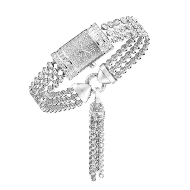 Boucheron's new Pompon high jewellery watch has the iconic Reflet case created by the house in 1947. Snow set with diamonds on the dial and framed by baguette and round-cut diamonds on the bezel, the bracelet is formed of three strands of diamonds.