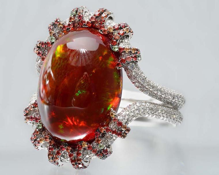 Martin Katz white gold ring with a 13.18ct oval red opal cabochon, microset with diamonds, tsavorite garnets and orange-red sapphires.