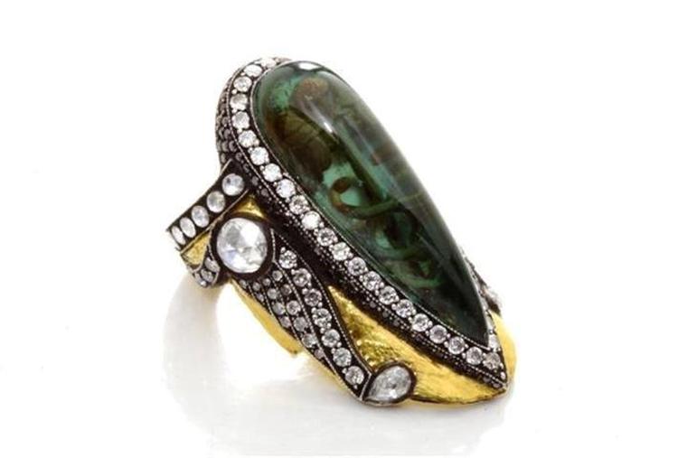 Sevan Biçakçi one-of-a-kind gold and sterling silver ring featuring an inversely carved green tourmaline centre stone with an intaglio inscription surrounded by diamonds.