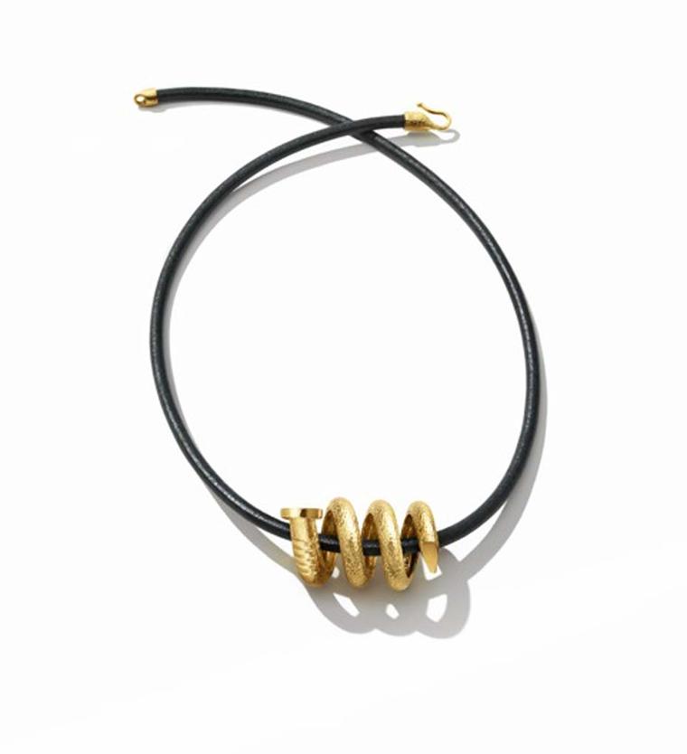 David Webb Tool Chest Collection Spiral Nail pendant in hammered gold ($2,400) or on a leather and gold cord as pictured ($575).