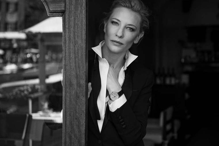 Wearing the IWC Portofino Midsize Automatic Day & Night watch featuring a red gold case set with 66 diamonds, Cate Blanchett looks on with sultry eyes at the camera.