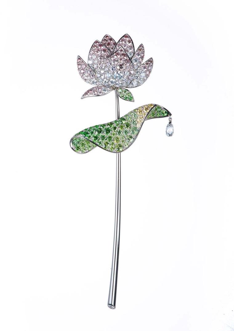 Gimel's platinum Lotus brooch from 2001 featuring a flower head with pavé-set pink and colourless diamond petals leading to a circular-cut demantoid garnet and yellow diamond leaves. © Gimel Trading Co., Ltd.
