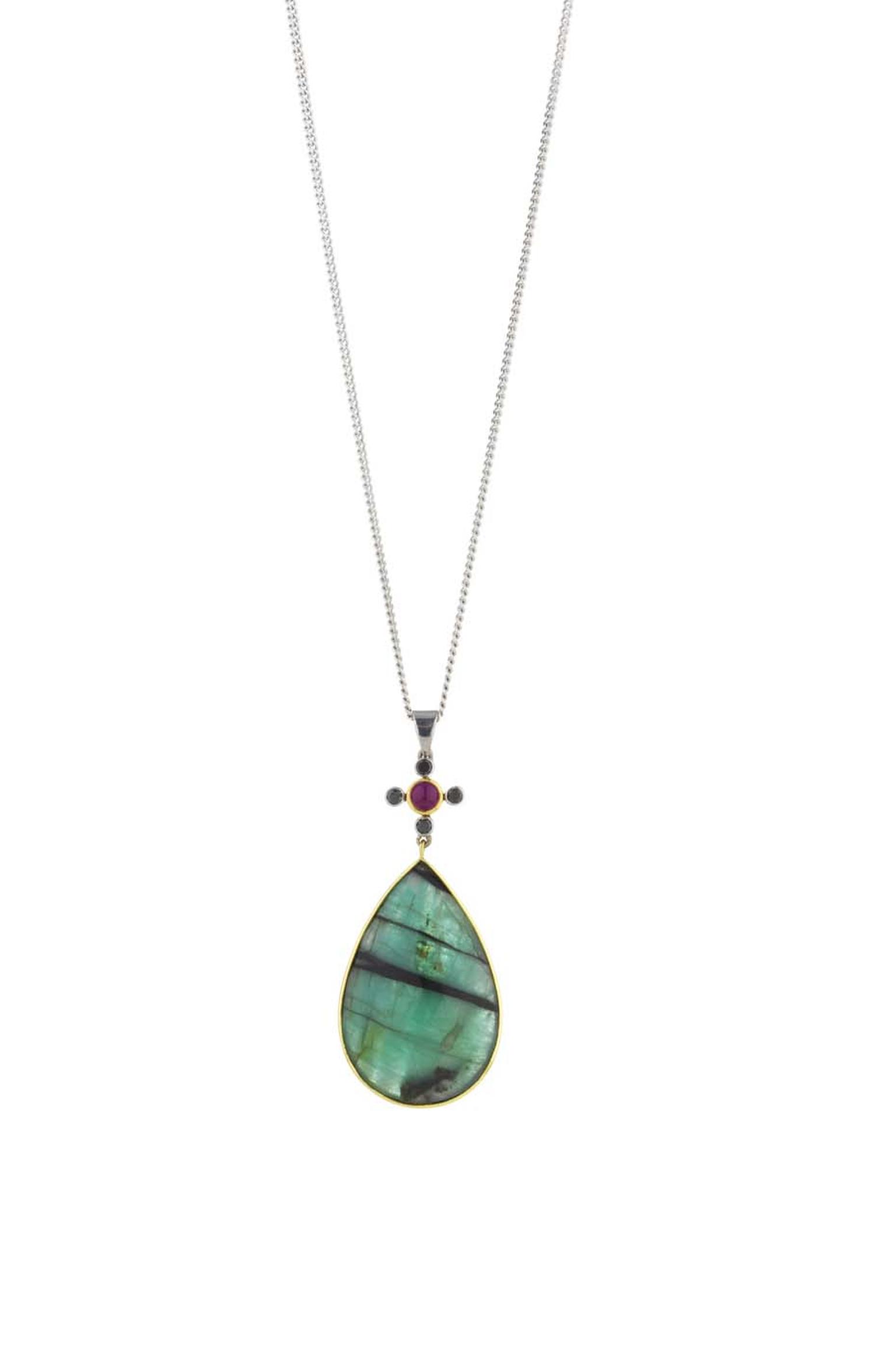 Holts London Portobello pendant with a rose-cut emerald drop with black inclusions suspended from a cross set with a ruby cabochon and black diamonds (£1,845).