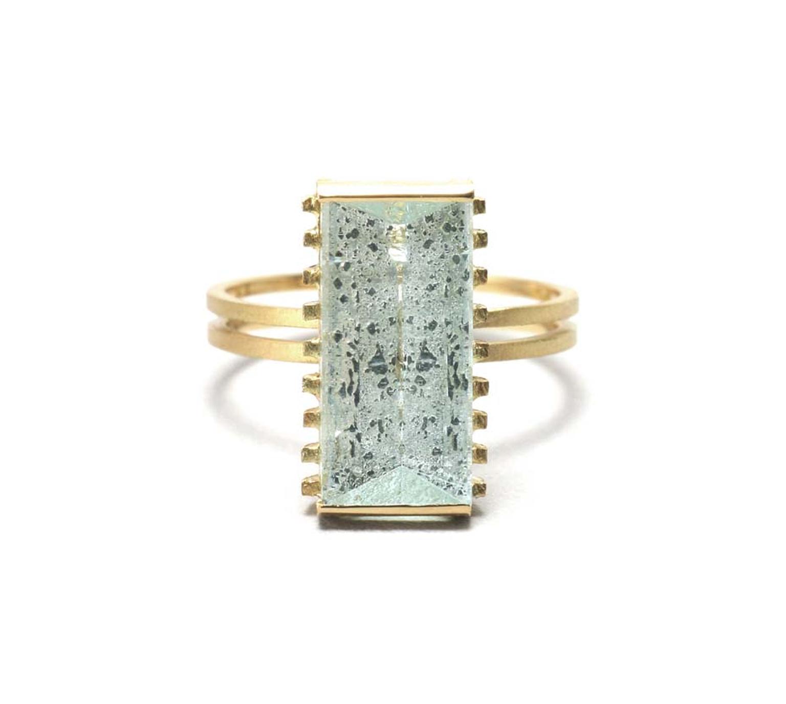 Shimell and Madden's Prism collection Rough Aqua Strut ring in textured gold with a 4.35ct mirror-cut aquamarine.