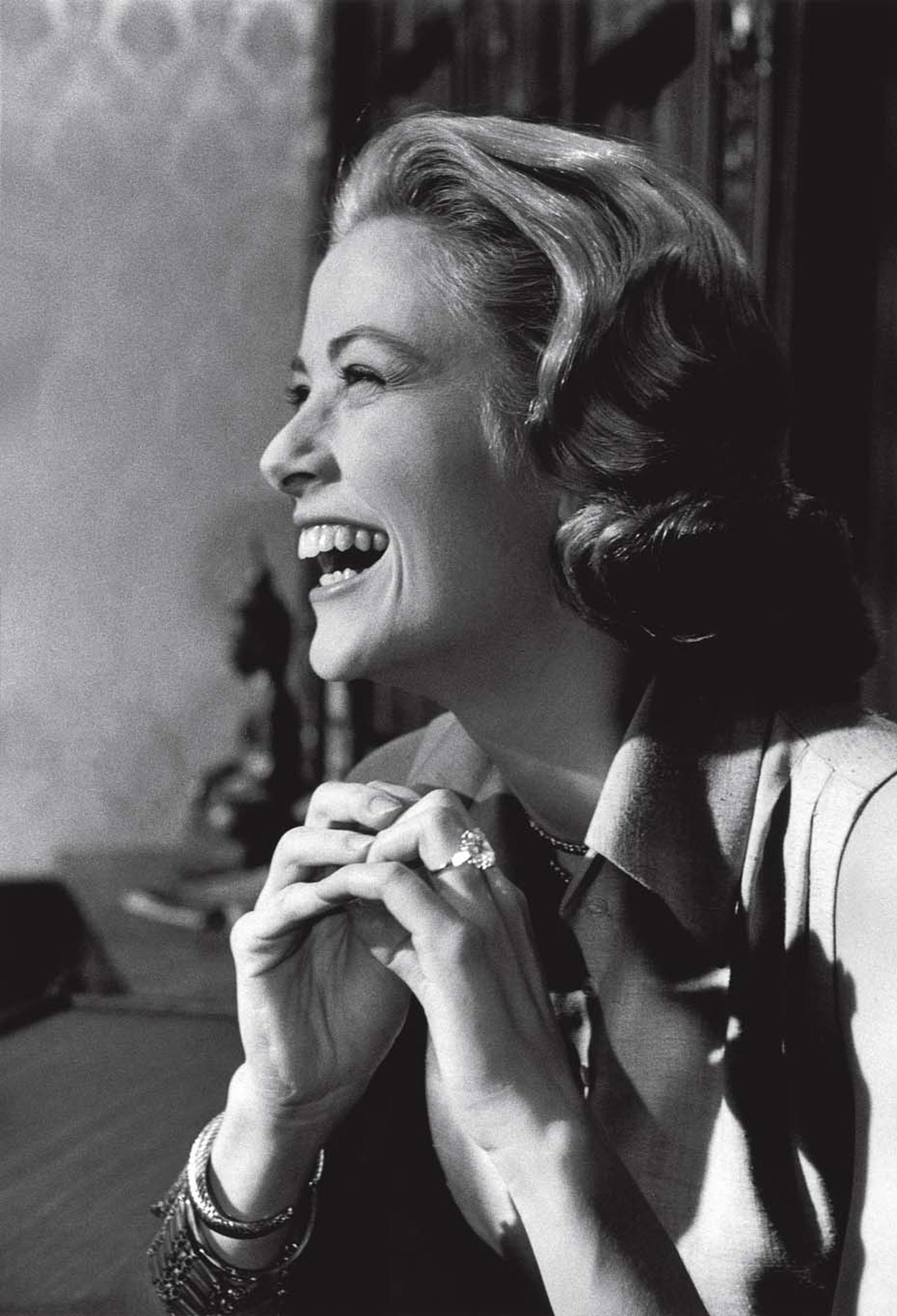 Princess Grace Kelly wearing her 10.47ct Cartier diamond engagement ring, given to her by Prince Rainier III.