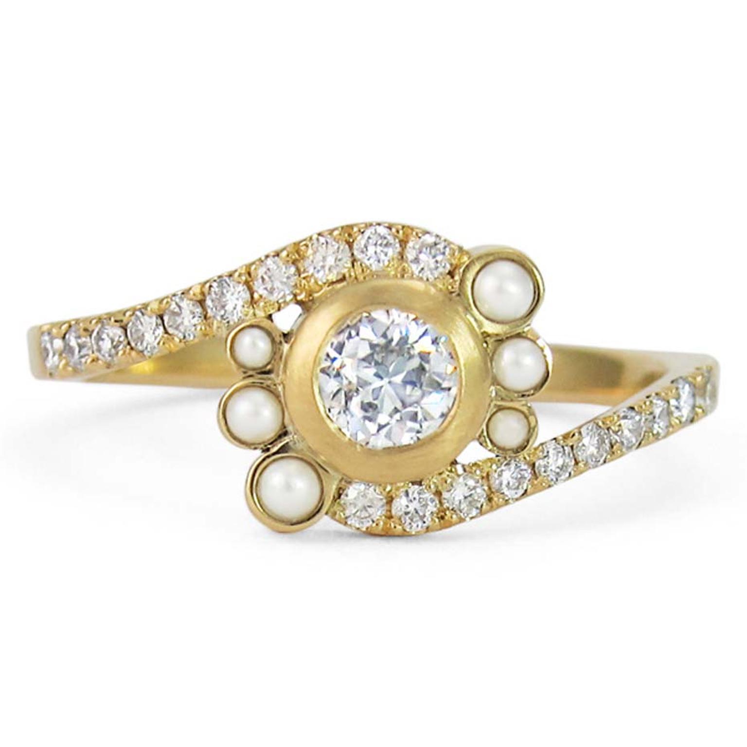 Jessica Poole engagement ring featuring a centre brilliant-cut diamond encircled by 6 pearls and a pavé diamond band.