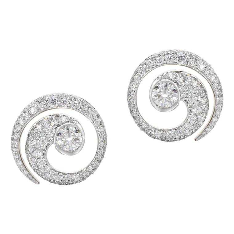 Jessica McCormack Mini Tattoo diamond earrings are inspired by Maori tattoos. At its core is a large, single, round brilliant diamond that leads into a beguiling diamond pavé spiral pattern with a total diamond weight of over 3ct.