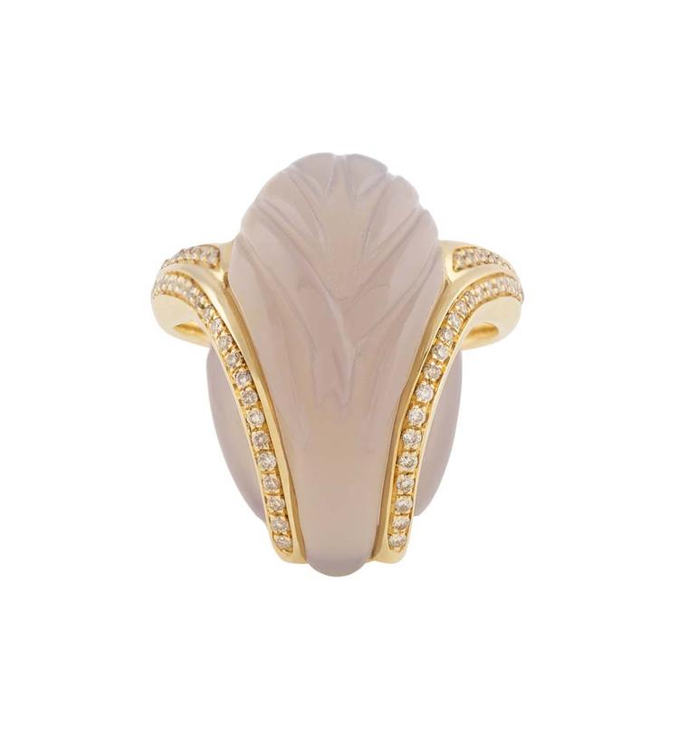 Noor Fares Fly Me to the Moon yellow gold ring with an almond-shaped mother-of-pearl stone with carved wing details and insets of diamonds with a yellow gold setting.