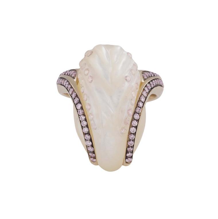 Noor Fares Fly me to the Moon ring featuring a white mother-of-pearl stone with carved wing details and insets of pale pink diamonds with a grey gold setting encrusted with pink diamonds.