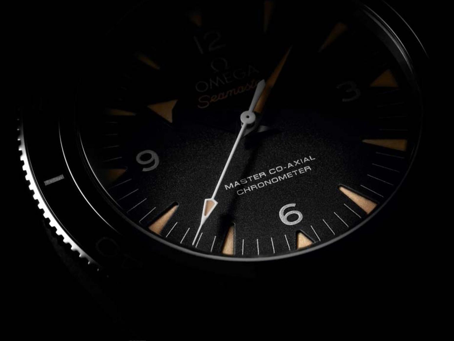 The Omega Seamaster 300 Master Co-Axial 41mm watch features a black sandblasted dial which offsets the beige vintage SuperLumiNova hour markers.