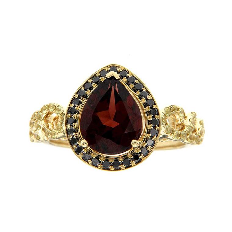 H.AZEEM King Bird of Paradise ring in yellow gold, set with a central pyrope garnet, black diamonds and yellow sapphires.