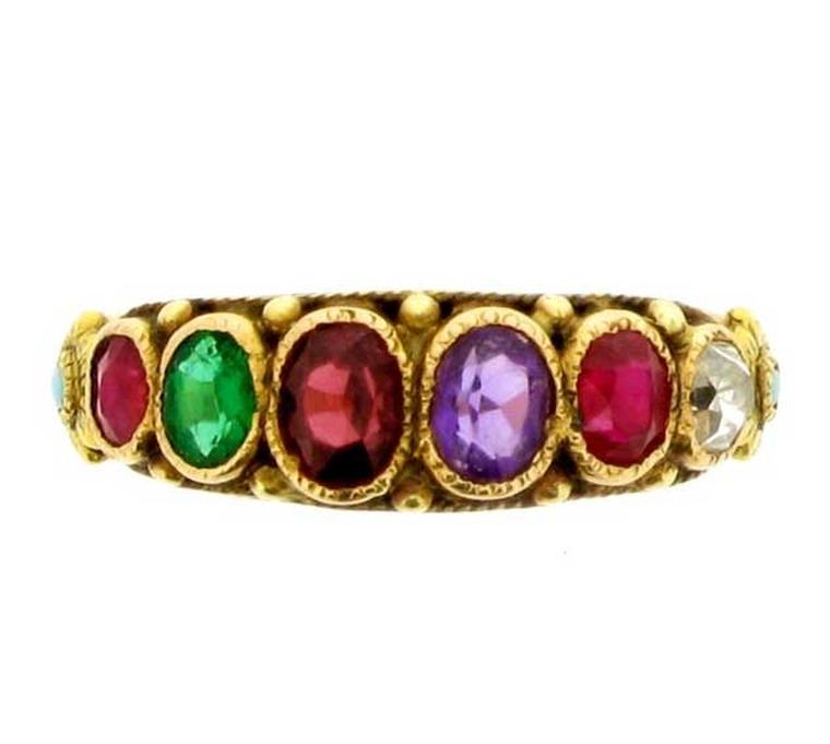 This antique Regard ring in yellow gold is set with a ruby, emerald, garnet, amethyst and diamond. Available from Berganza.