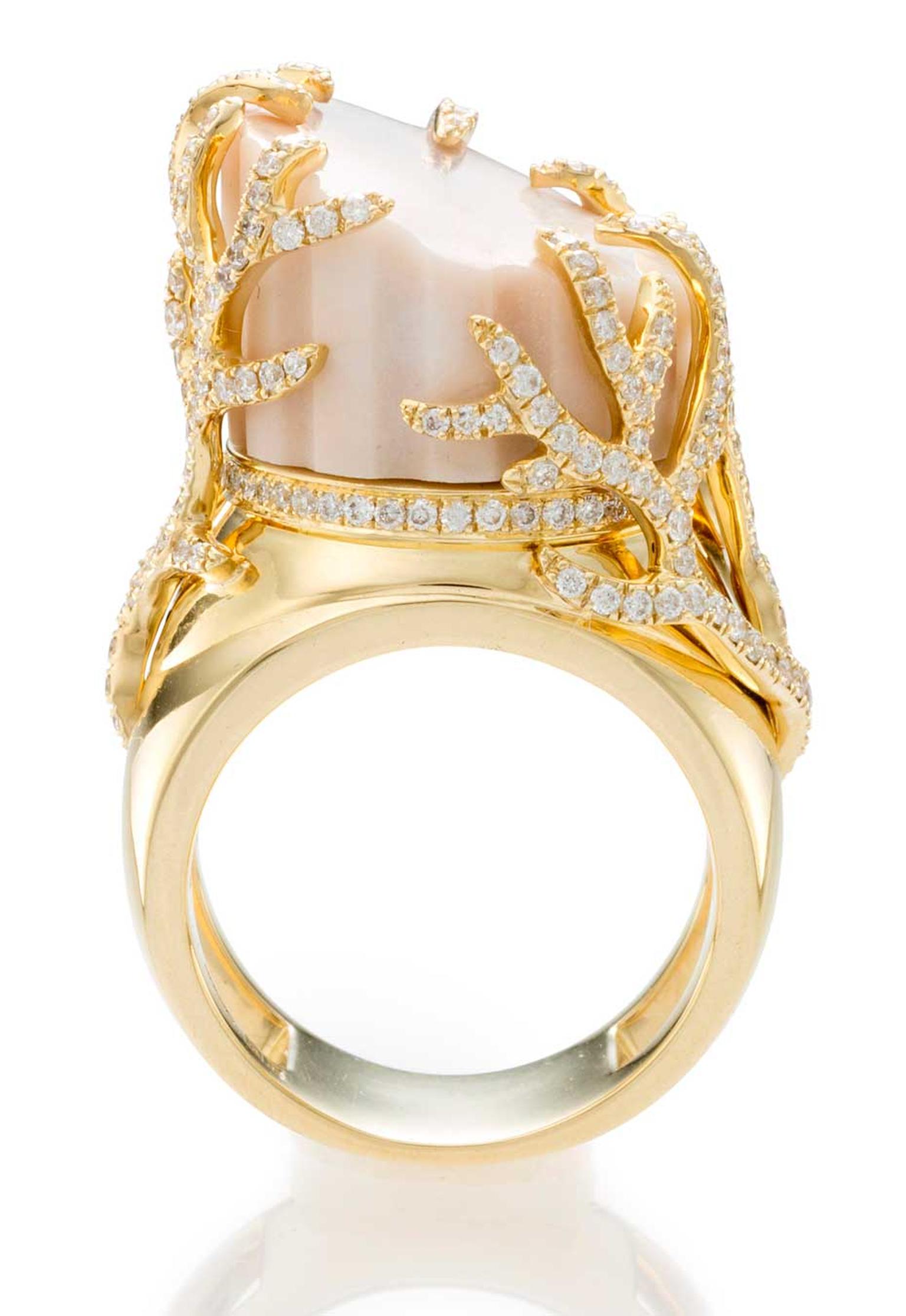 The marble in this CompletedWorks ring is surrounded by a circular-cut diamond and gold vine motif, with Great Britain assay marks.