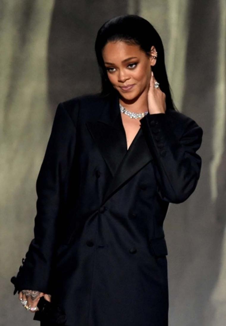 Rihanna teamed her oversized tuxedo jacket with some impressive high jewelry, including a Harry Kotlar 8.00ct pear-shaped diamond ring worth $1 million, a selection of Chopard rings and a stunning Chopard diamond necklace set in platinum, as she took to t