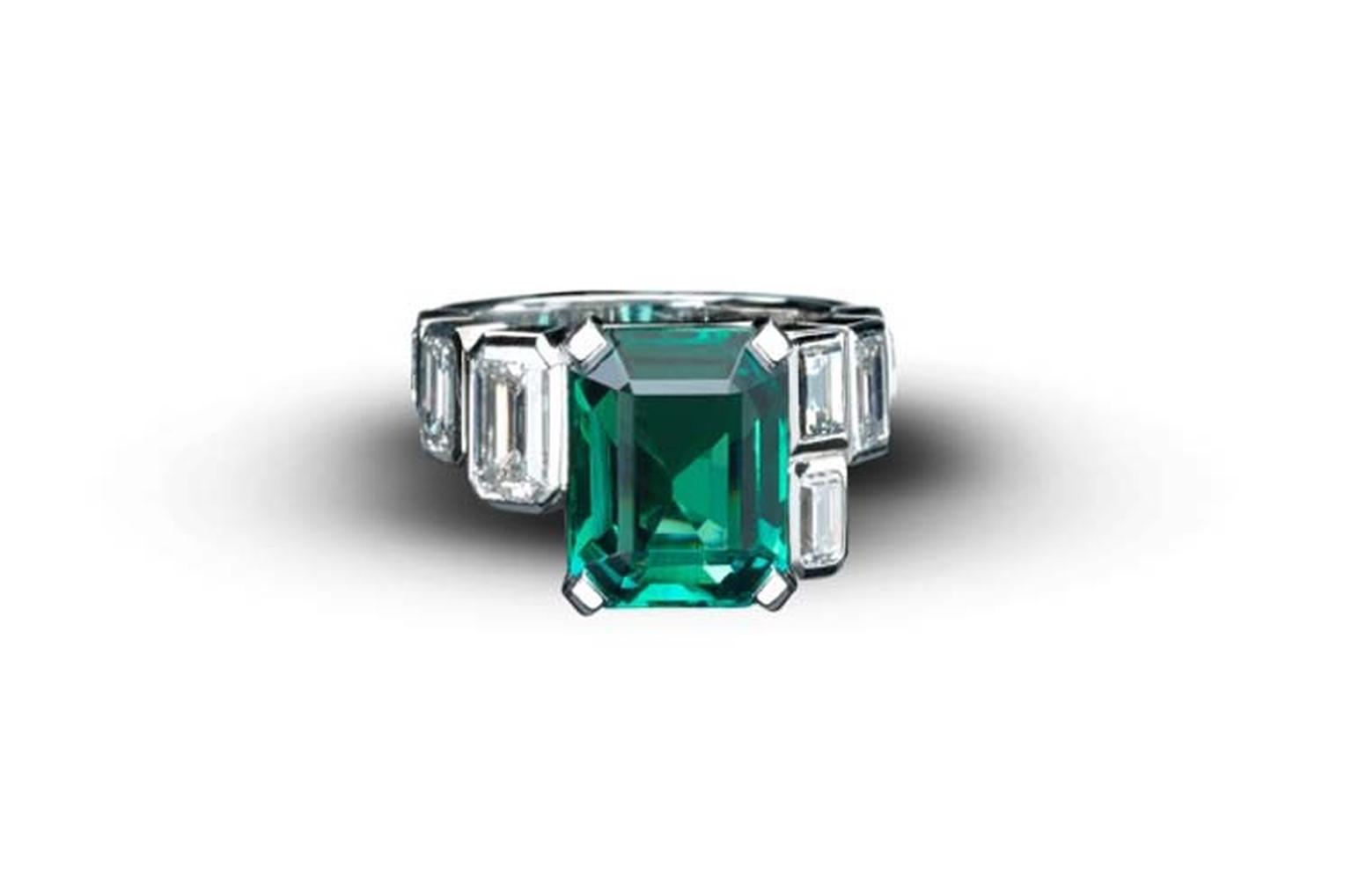 Emerald Art Deco Style ring from Star Diamond, with a central African emerald, weighing 5.9cts, flanked with white emerald cut diamonds of 2.73cts set in white gold.