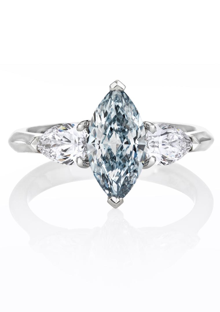 De Beers marquise-cut blue diamond engagement ring flanked by white diamonds.