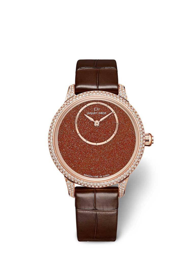 Jaquet Droz Petite Heure Minute Sunstone watch with a Sunstone dial, off-centred hours and minutes disc, and a 35mm rose gold case set with 232 diamonds. Limited edition of 88 pieces.