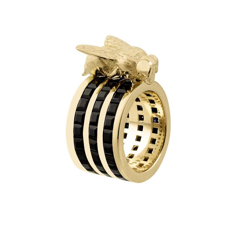 Tessa Packard's 18ct yellow gold Cocktail Sting ring from the Predator/Prey collection, featuring three bands of channel-set black sapphires topped with a solid gold wasp.