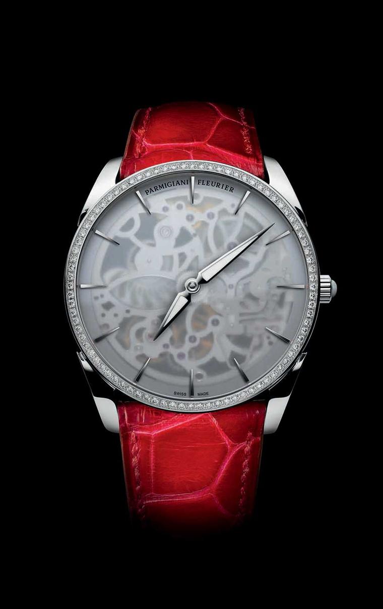 Parmigiani Tonda 1950 Squelette ladies' watch reveals just a hint of the complex orchestration behind the frosted dial. Shown here is the 39mm white gold model with a diamond-set bezel and red Hermès strap.