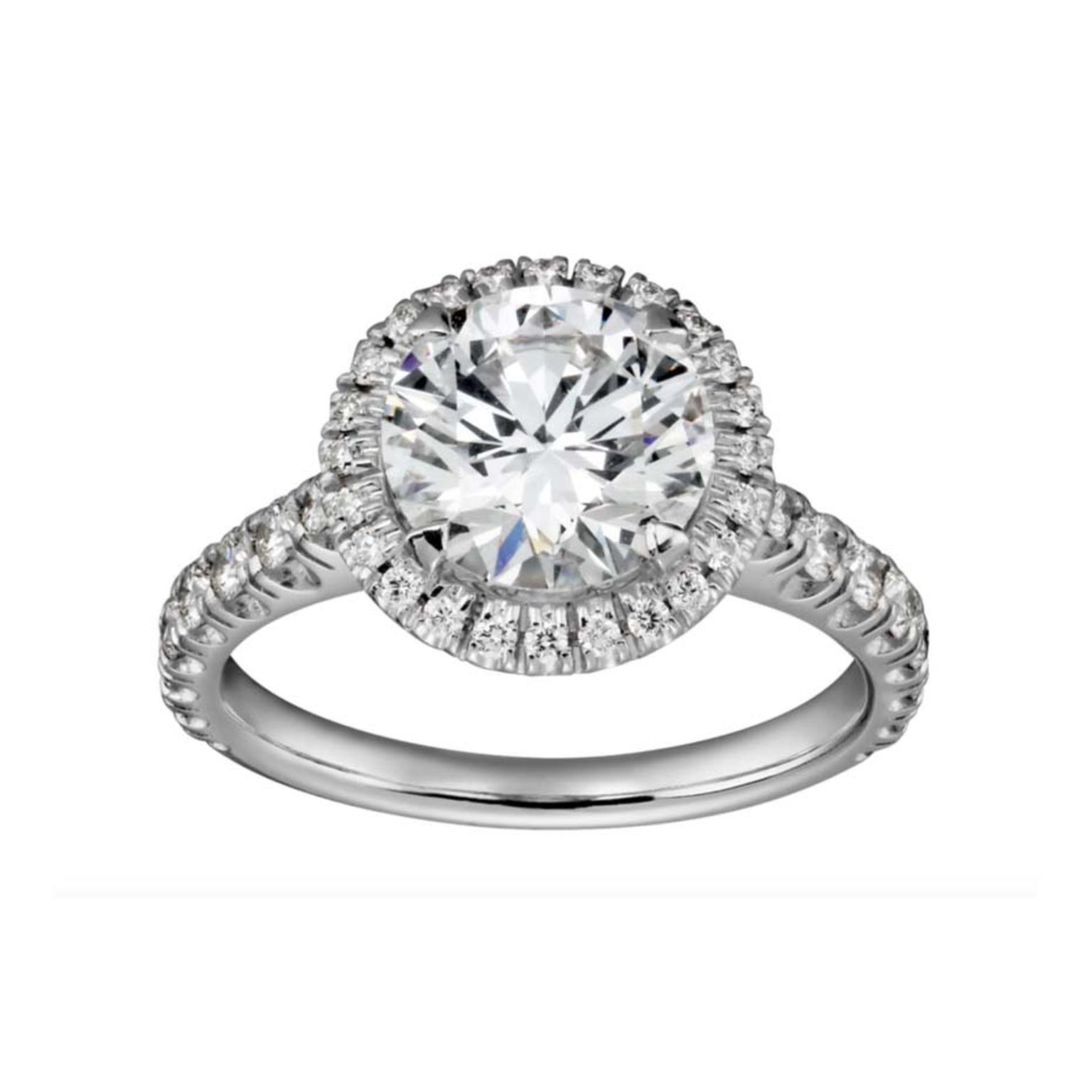 Cartier jewellery Destinée solitaire platinum engagement ring, enhanced by a halo of micro pavé diamonds surrounding a central brilliant-cut diamond.