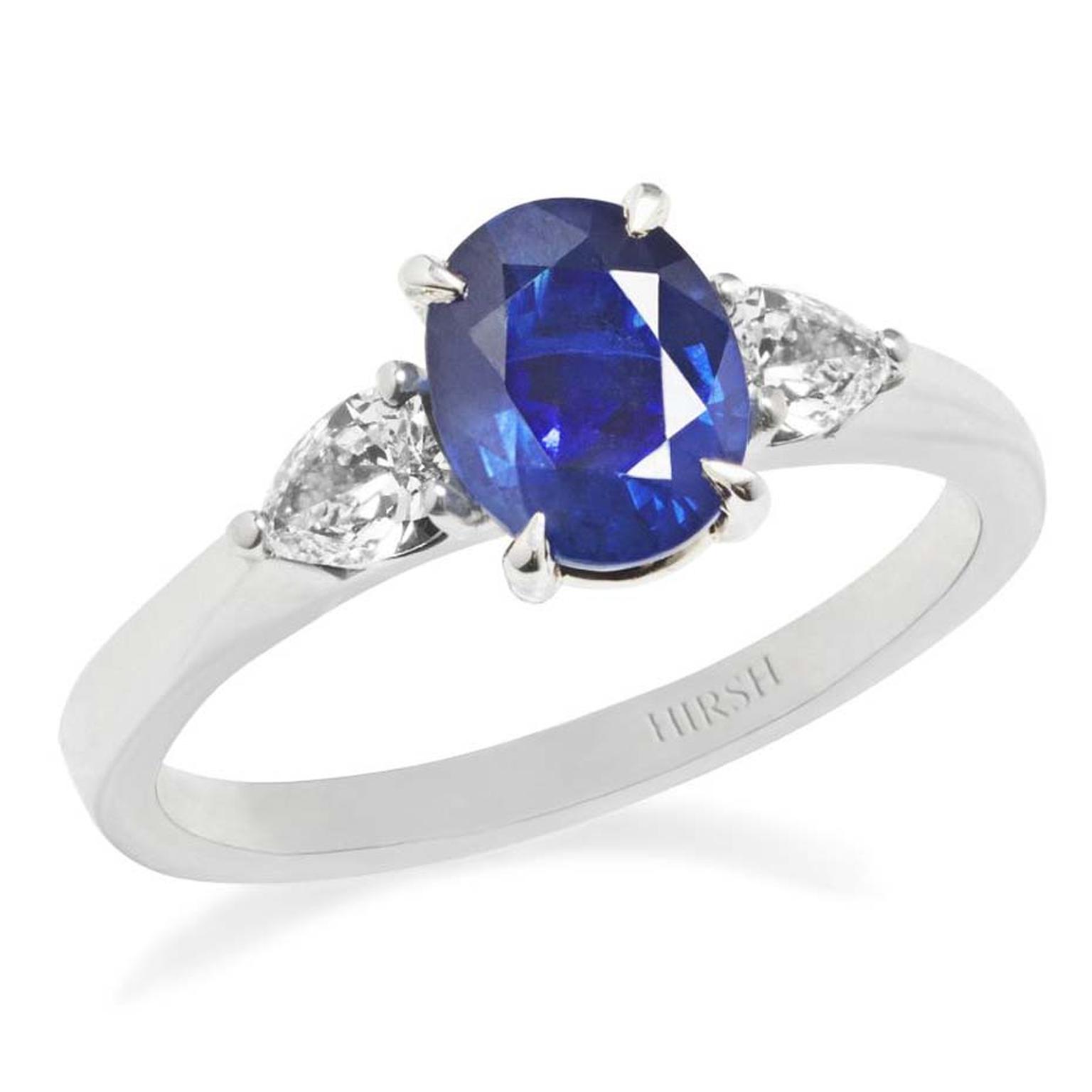 A blue sapphire ring with diamond side stones will never go out of fashion, like this Hirsh jewellery engagement ring with an oval-cut central sapphire, between two pear-shaped diamonds.