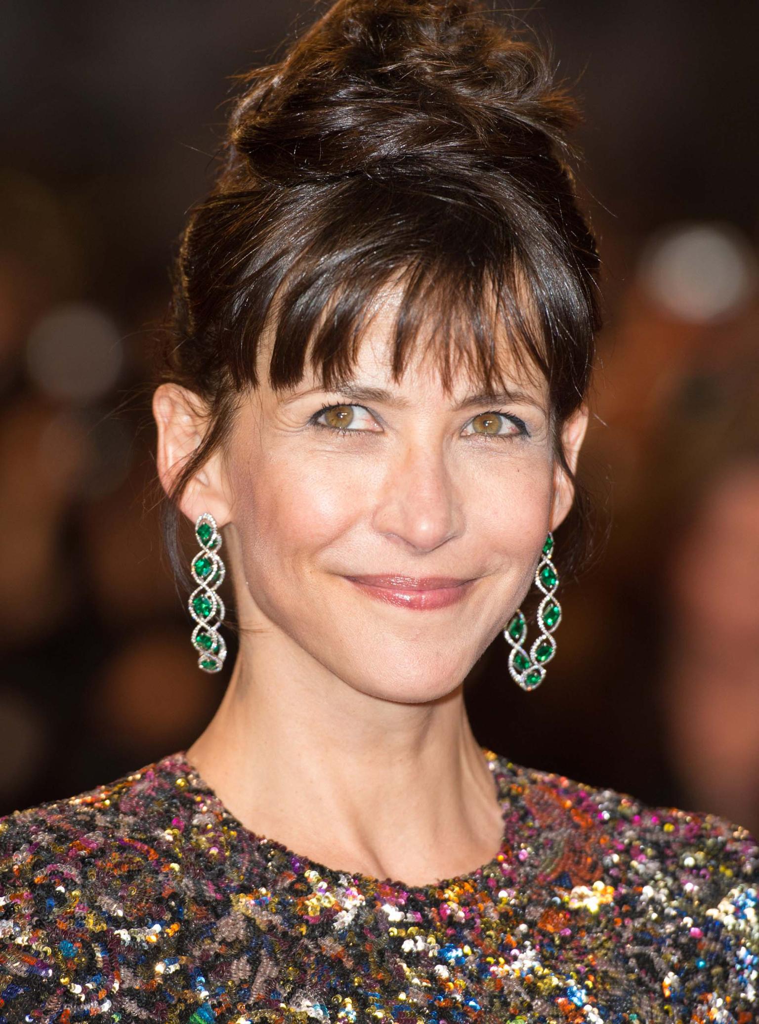 French actress and Cannes Film Festival Jury member, Sophie Marceau opted for colourful Chopard red carpet jewellery in the shape of emerald earrings set in titanium.