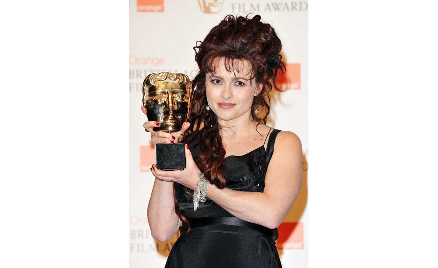 Helena Bonham Carter collects her BAFTA award wearing Solange Azagury-Partridge bracelet and earrings