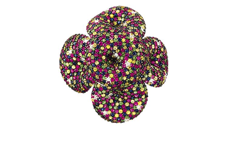 Lot 42. An unusual multi-gem cocktail ring. Designed as a moveable flowerhead, the centre and each undulating petal decorated with finely pavé-set coloured sapphires, diamonds, rubies and tsavorite garnets to the openwork gallery with plain hoop...