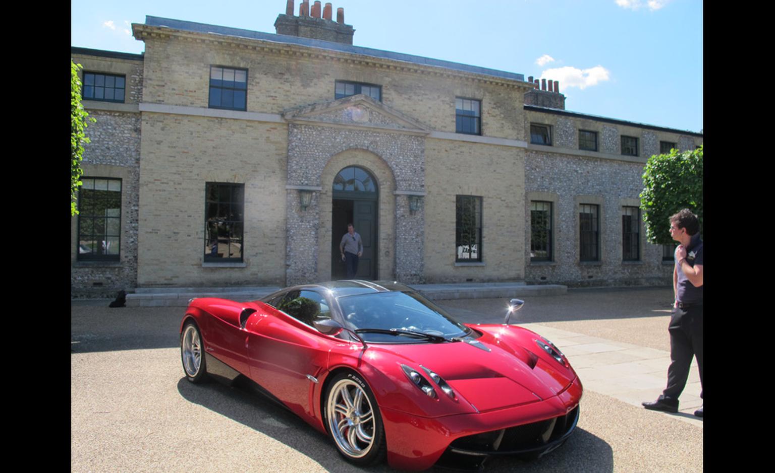 Here you are, at last, a picture of a complete car. This red roarer was outside the entrance to The Kennels golf club and I believe it is a Pagani.