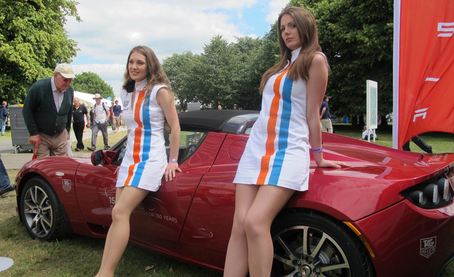 And the girls are out in their Gulf racing stripes for TAG Heuer and leaning against the Tesla eco-sports mobile.