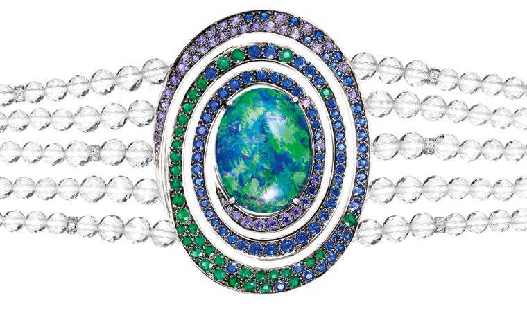 Aiguebelle  bracelet,  set  with  an  oval  opal  cabochon   and  rock  crystal  beads,  set  with  emeralds,  blue  and   purple  sapphires  and  diamonds,  on  white  gold. POA
