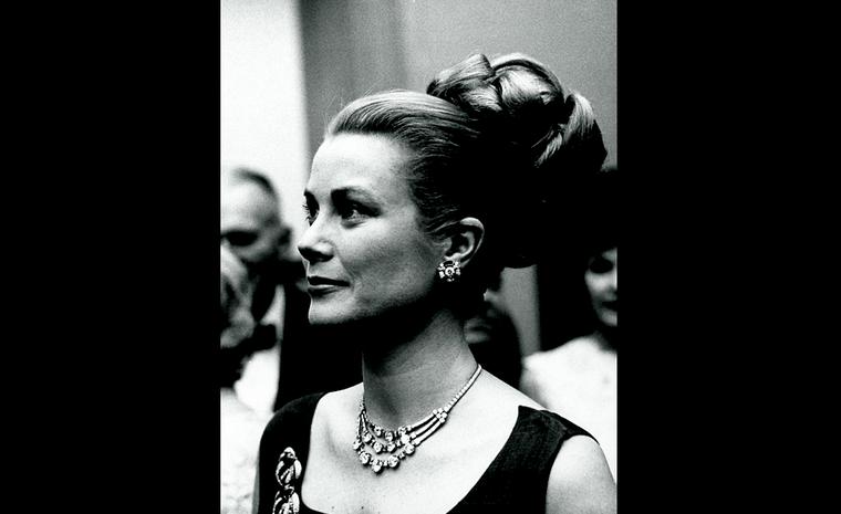 Princess Grace of Monaco wearing hair in elaborate bun & adorned w. stunning Cartier diamond necklace, at party.  (Photo by Jack Rosen/Pix Inc./Time Life Pictures/Getty Images)