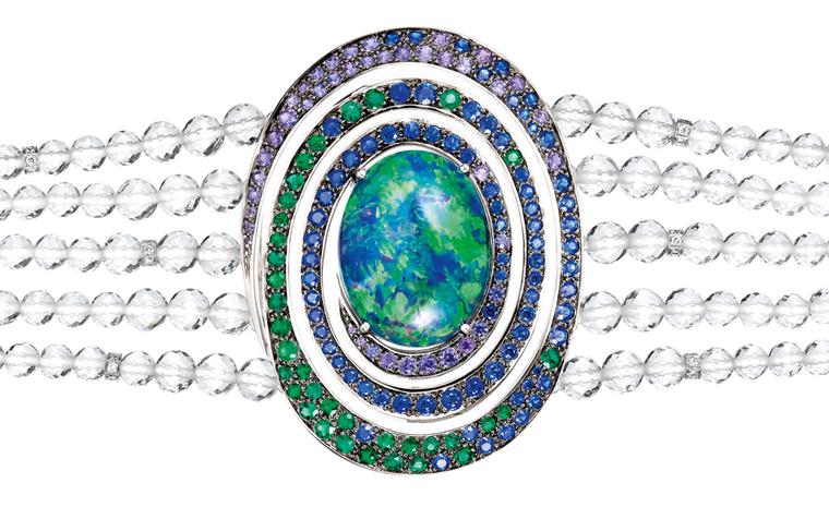 BOUCHERON. Aiguebelle bracelet, set with an oval opal cabochon and rock crystal beads, set with emeralds, blue and purple sapphires and diamonds, on white gold. POA